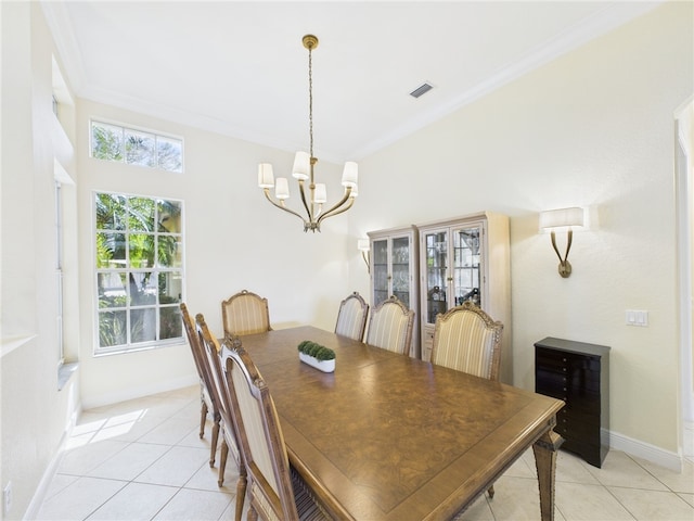 dining area with baseboards, visible vents, light tile patterned flooring, crown molding, and a notable chandelier