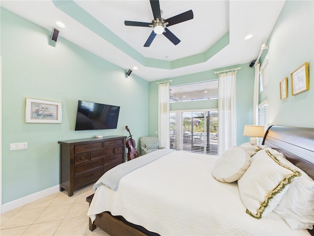 bedroom featuring baseboards, ceiling fan, recessed lighting, tile patterned floors, and a raised ceiling