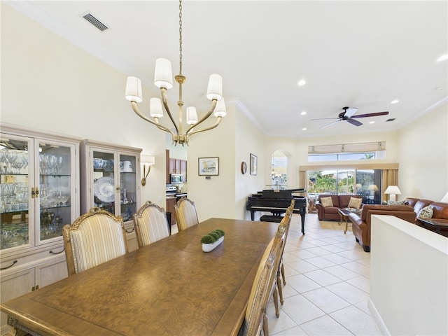 dining area with visible vents, crown molding, recessed lighting, arched walkways, and light tile patterned flooring