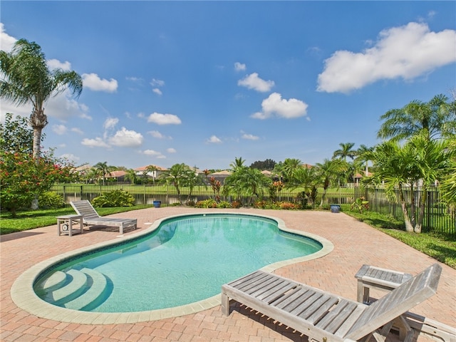 view of pool featuring a fenced backyard, a fenced in pool, and a patio