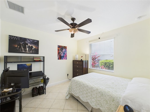 tiled bedroom with visible vents, a ceiling fan, and baseboards