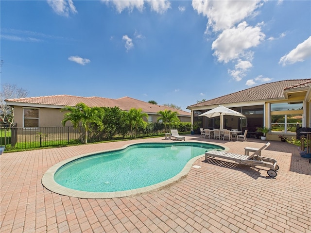 view of swimming pool with a fenced in pool, fence, and a patio area