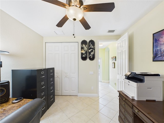 office space with light tile patterned floors, a ceiling fan, baseboards, visible vents, and arched walkways