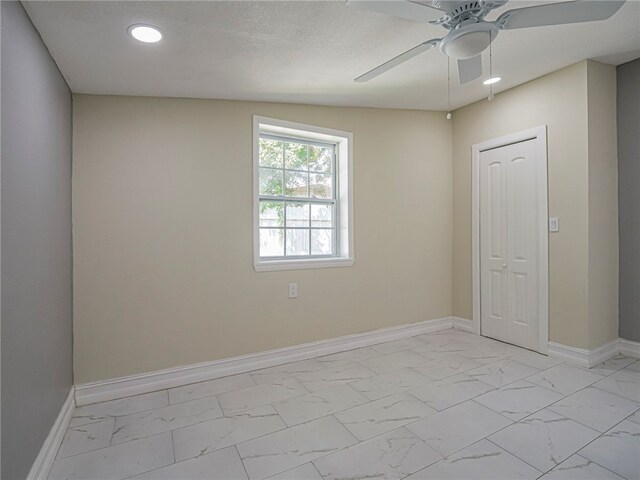 unfurnished room with a textured ceiling, ceiling fan, and vaulted ceiling