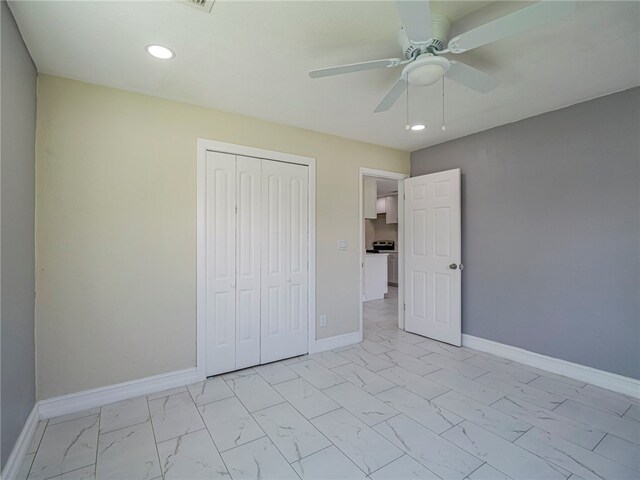 unfurnished bedroom featuring ceiling fan and a closet