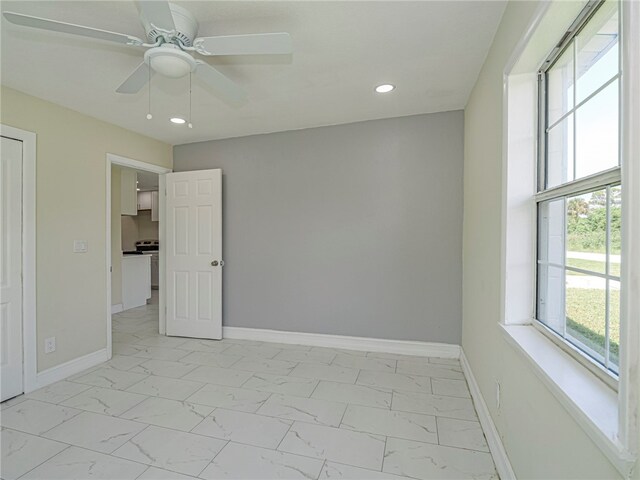 spare room featuring a wealth of natural light and ceiling fan