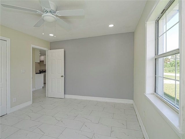 339 6th Ave SW, Vero Beach, FL 32962 - unfurnished bedroom with light marble finish flooring, recessed lighting, and a ceiling fan