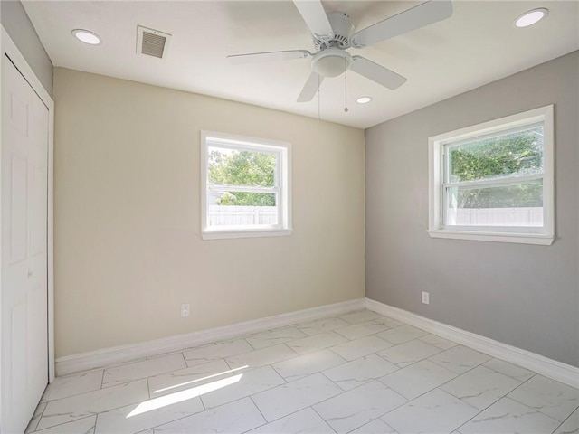 339 6th Ave SW, Vero Beach, FL 32962 - unfurnished bedroom with light marble finish flooring, recessed lighting, a closet, and ceiling fan