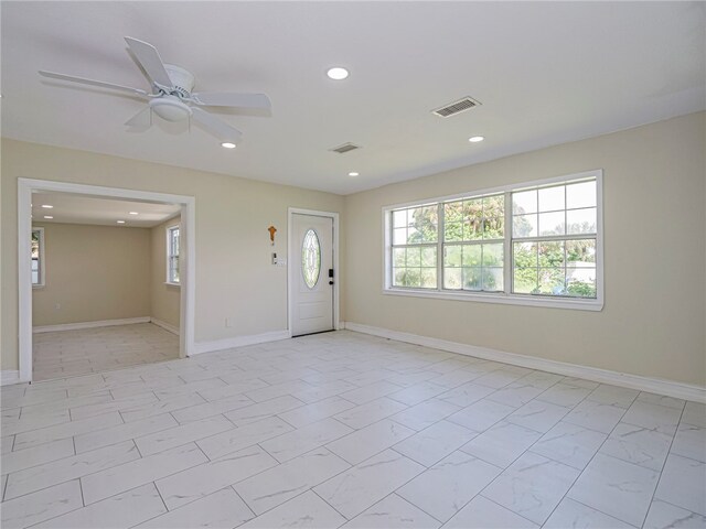 foyer entrance featuring ceiling fan