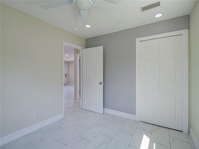 339 6th Ave SW, Vero Beach, FL 32962 - unfurnished bedroom featuring light marble finish flooring, a closet, ceiling fan, and recessed lighting