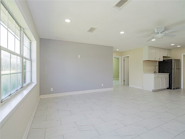 spare room with ceiling fan and sink