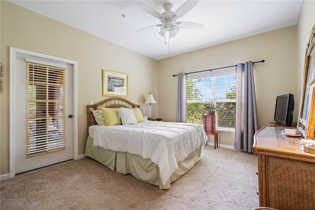 bedroom featuring access to outside, light colored carpet, and ceiling fan