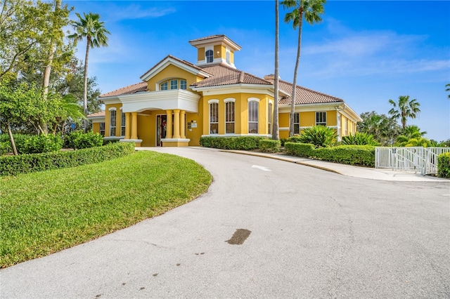 mediterranean / spanish-style home with a front lawn