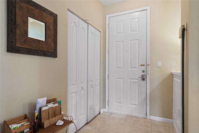 entryway with light tile patterned floors