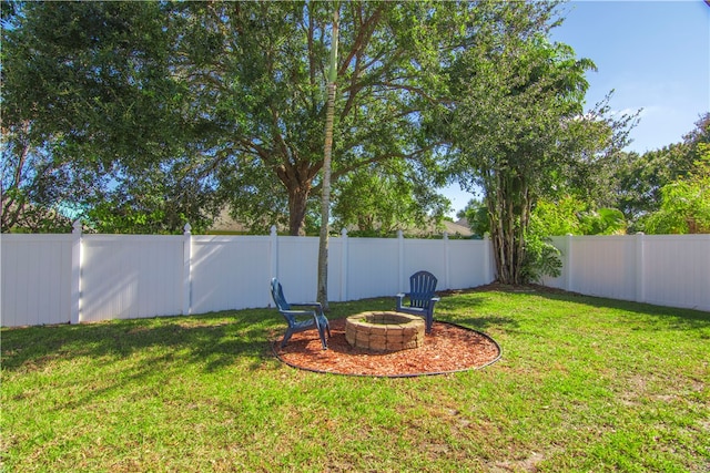 view of yard featuring an outdoor fire pit