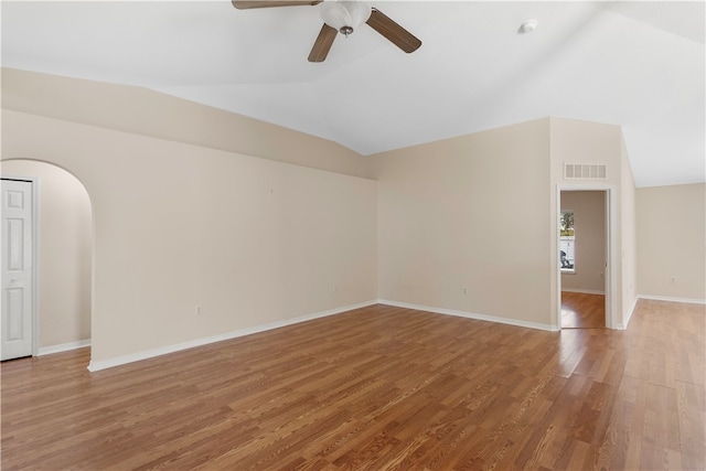 spare room featuring hardwood / wood-style flooring, vaulted ceiling, and ceiling fan