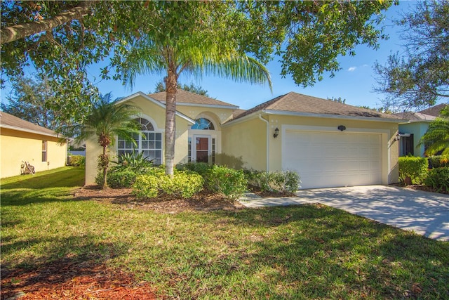 view of front of house featuring a front yard and a garage