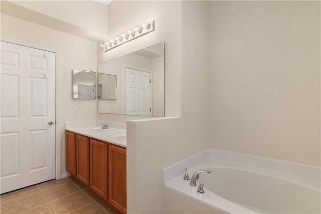 bathroom featuring a tub, tile patterned flooring, and vanity