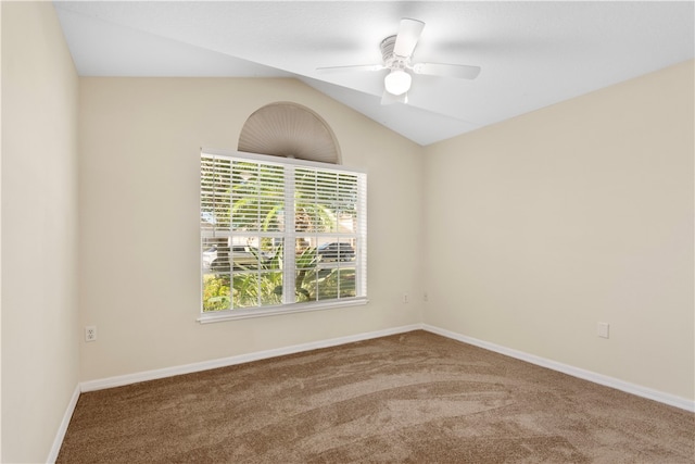 spare room featuring carpet flooring, ceiling fan, and lofted ceiling