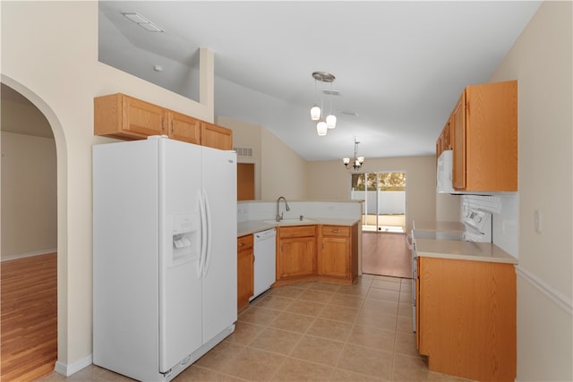 kitchen with white appliances, backsplash, an inviting chandelier, sink, and decorative light fixtures