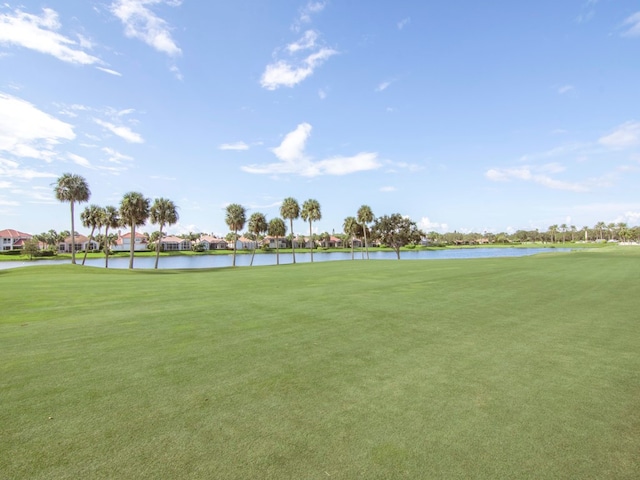 view of home's community featuring a water view and a yard