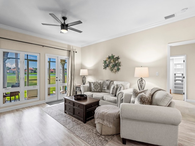 living room featuring ceiling fan, light hardwood / wood-style flooring, and ornamental molding