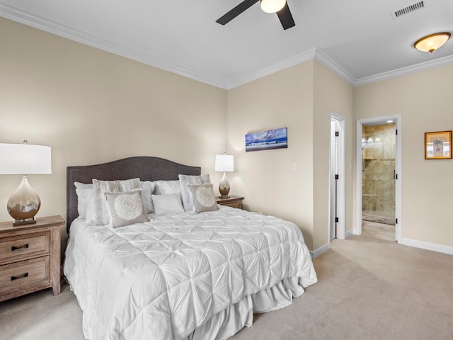 bedroom featuring ceiling fan, ensuite bath, light carpet, and crown molding