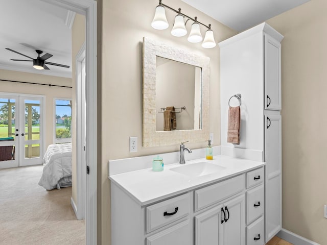 bathroom with ceiling fan, vanity, and crown molding