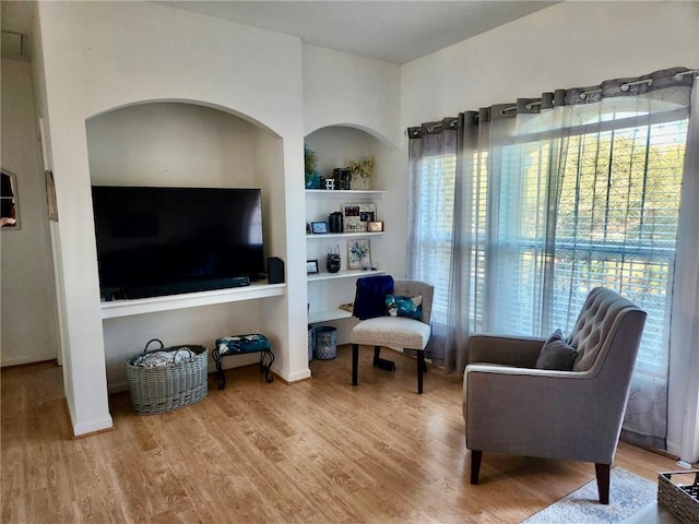 sitting room with hardwood / wood-style flooring