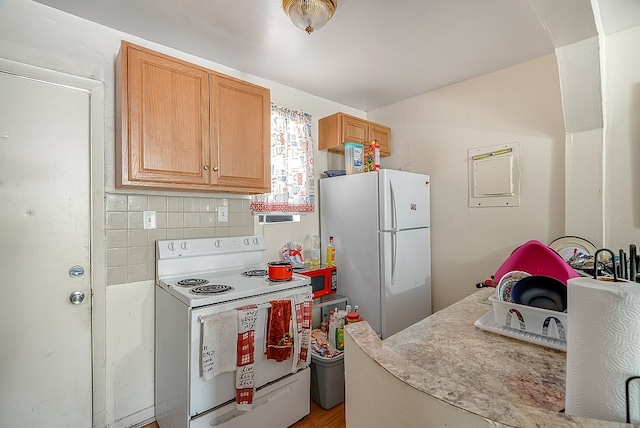 kitchen with decorative backsplash and white appliances