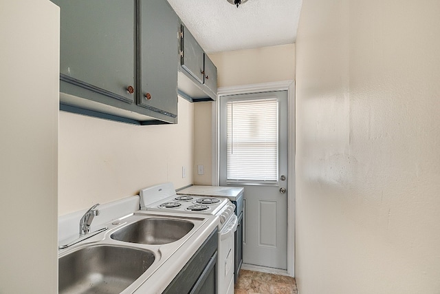 laundry room featuring a textured ceiling and sink