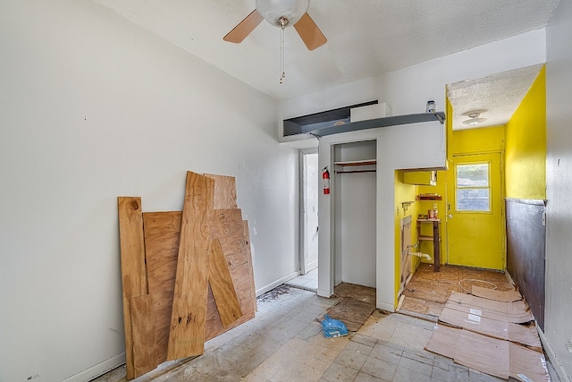 interior space featuring ceiling fan and a textured ceiling