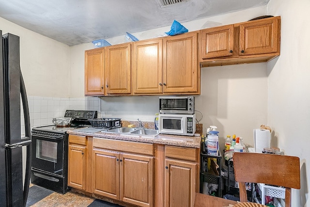 kitchen with backsplash, sink, and black appliances