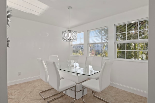 dining space with an inviting chandelier and light tile patterned flooring