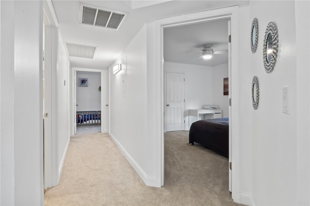 corridor with light colored carpet