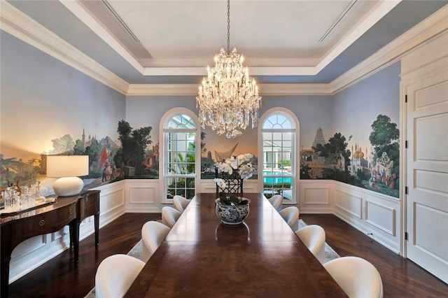 dining room with dark wood-type flooring, crown molding, and a tray ceiling