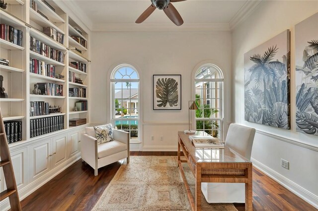 living area featuring dark hardwood / wood-style floors, crown molding, and ceiling fan