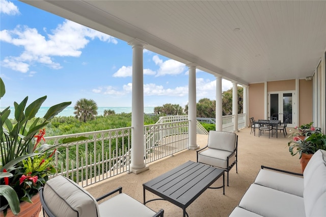 view of patio featuring a balcony and a water view