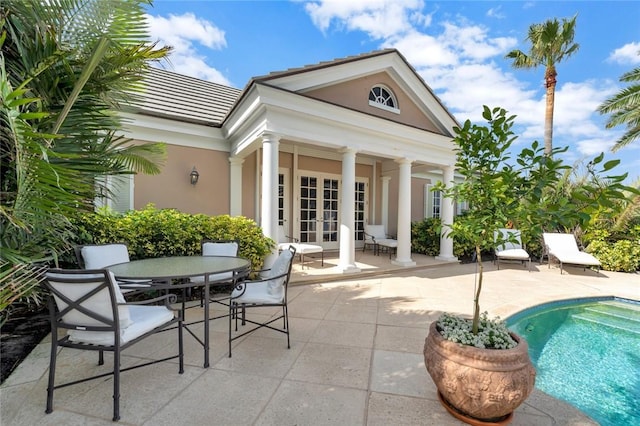 600 Ocean Rd, Vero Beach, FL 32963 - back of house with french doors, stucco siding, a patio, an outdoor pool, and outdoor dining area