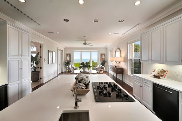 kitchen featuring dark wood-type flooring, ceiling fan, black appliances, and ornamental molding