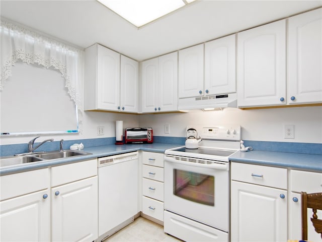 kitchen featuring white cabinetry, sink, and white appliances