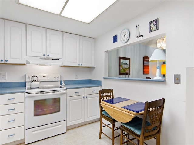 kitchen featuring white cabinets and white electric range oven