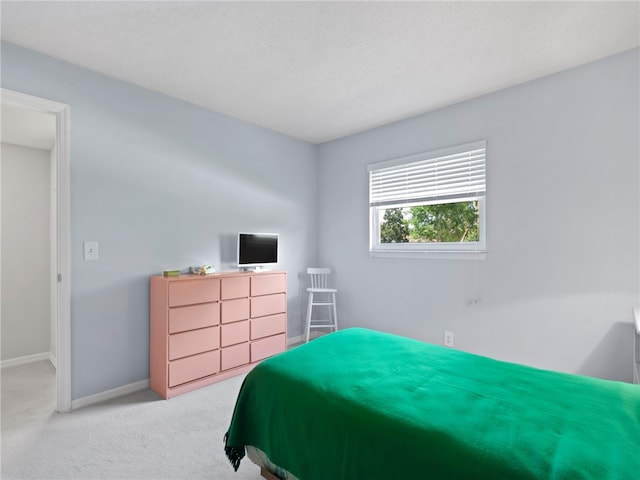 bedroom with a textured ceiling and carpet flooring