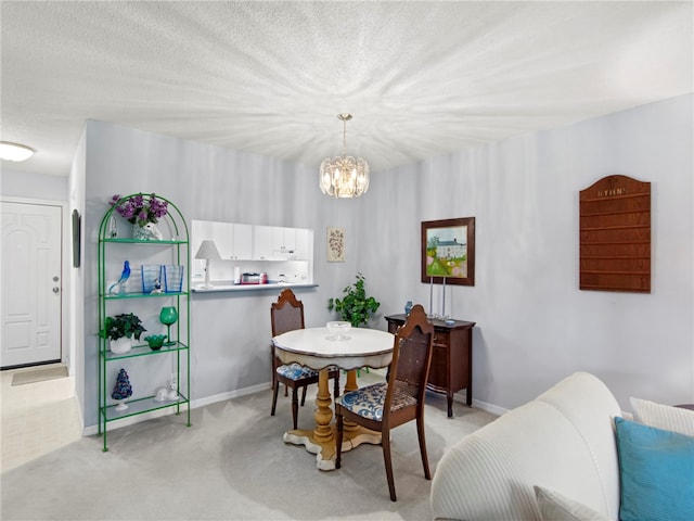 dining space featuring a textured ceiling, a notable chandelier, and light carpet