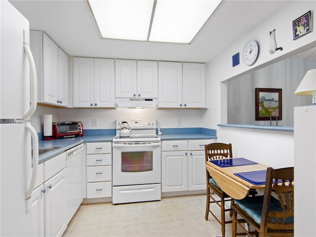 kitchen featuring white cabinets and white appliances