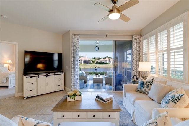 living room featuring ceiling fan and light tile patterned flooring