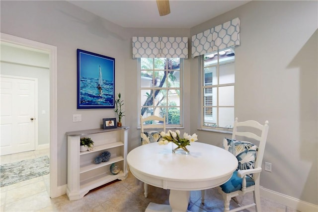 dining room with light tile patterned floors and ceiling fan