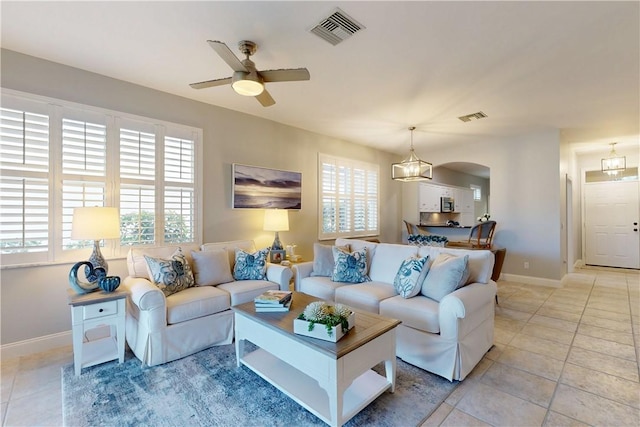 tiled living room with ceiling fan