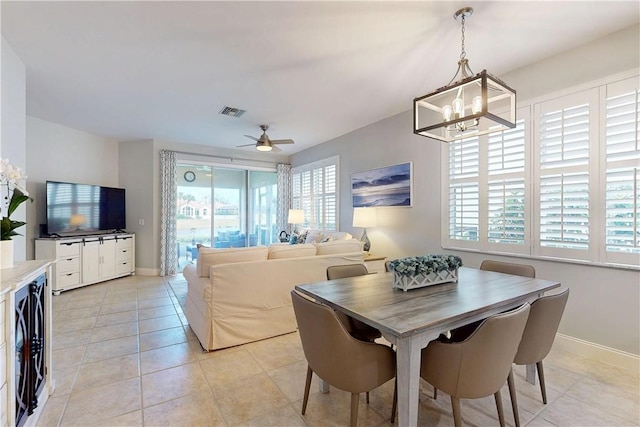 tiled dining space featuring wine cooler and ceiling fan