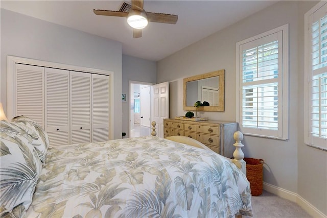 bedroom featuring ceiling fan, light carpet, and a closet